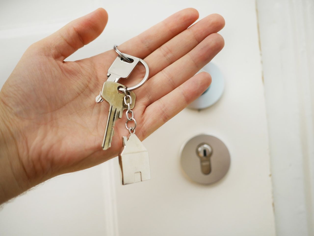 keys on hand next to a door