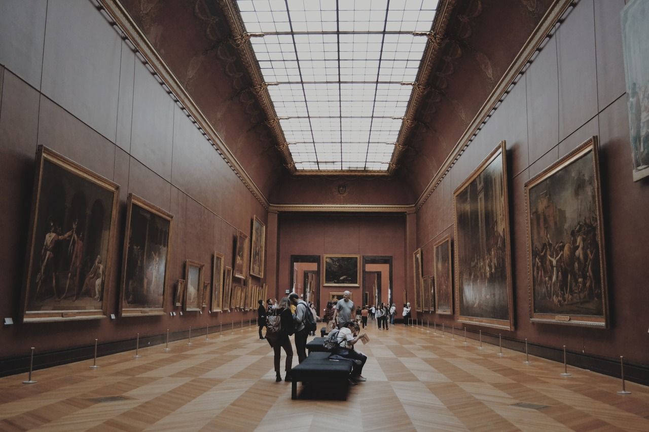 people looking at paintings at a museum