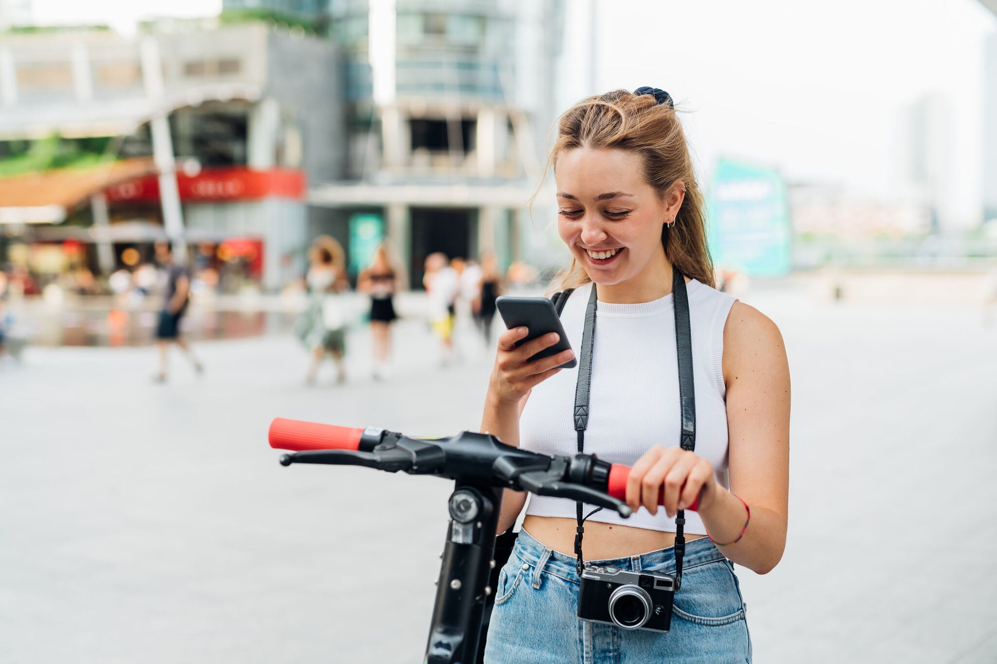 a woman looking at her phone and smiling