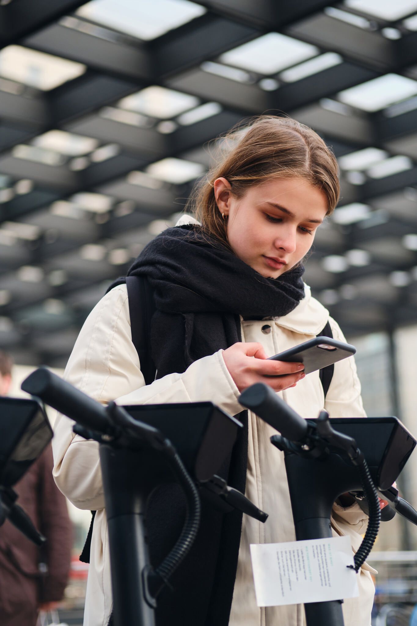 a girl scanning a QR code with a phone