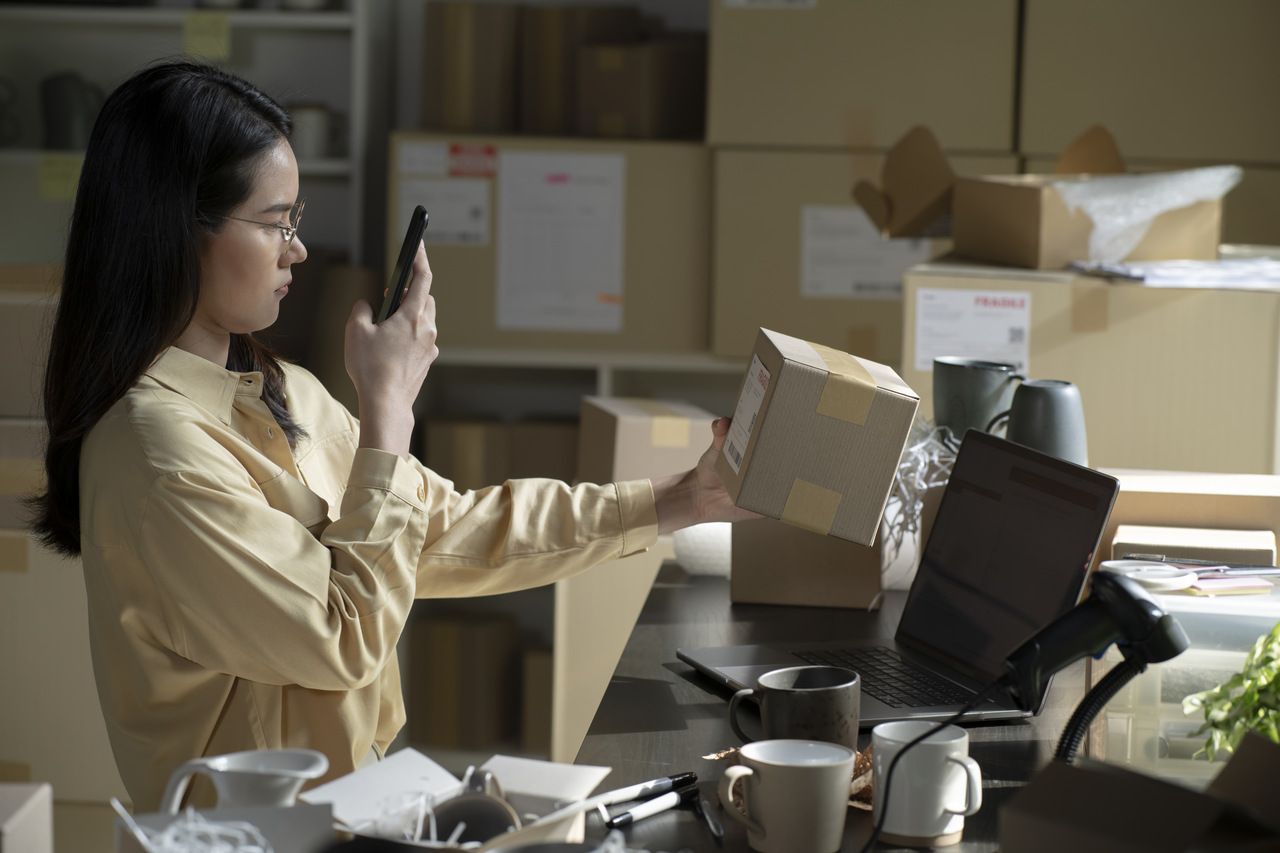 a woman wearing glasses scanning a QR code