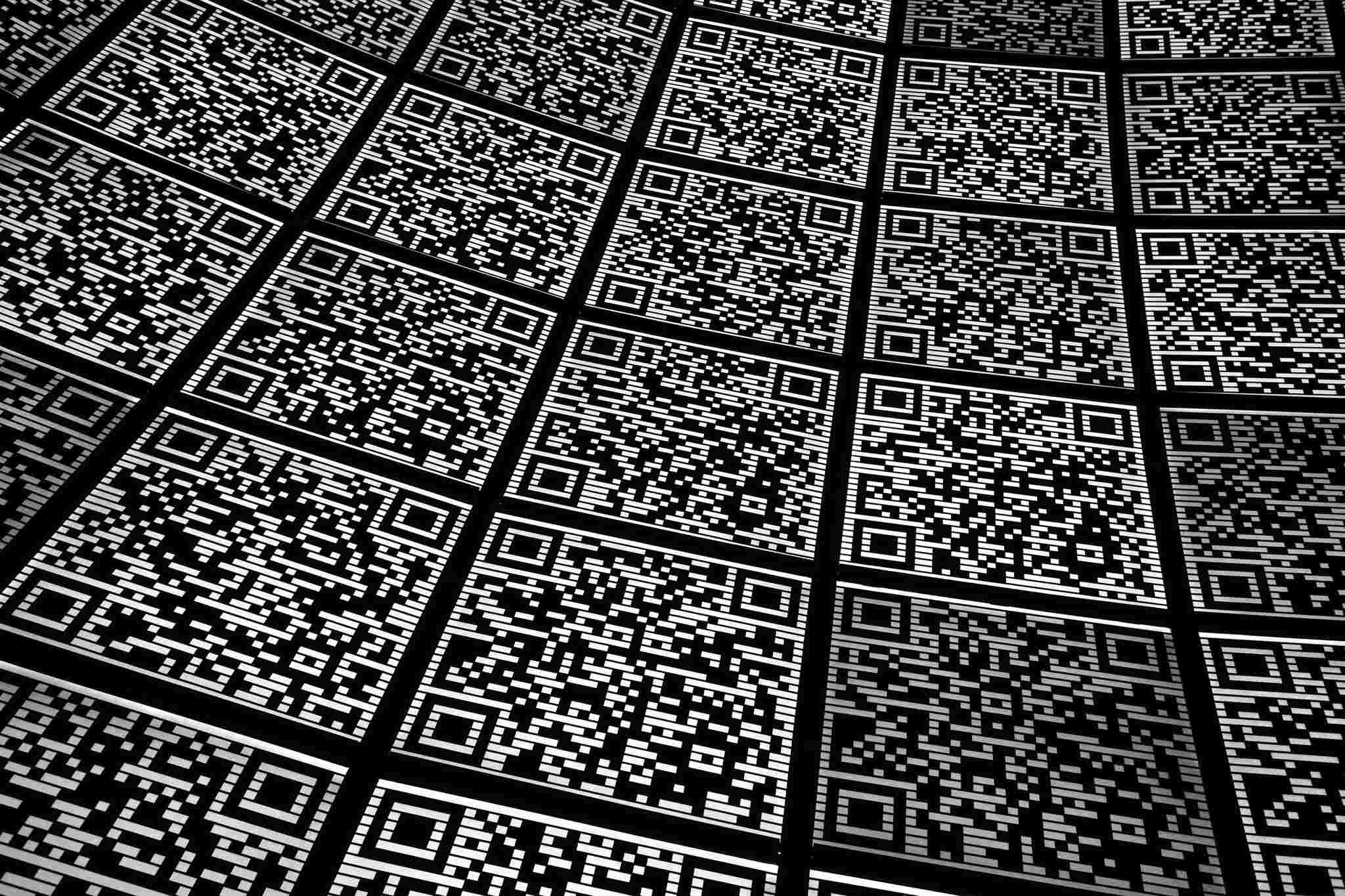 a bunch of QR codes on a big black screen