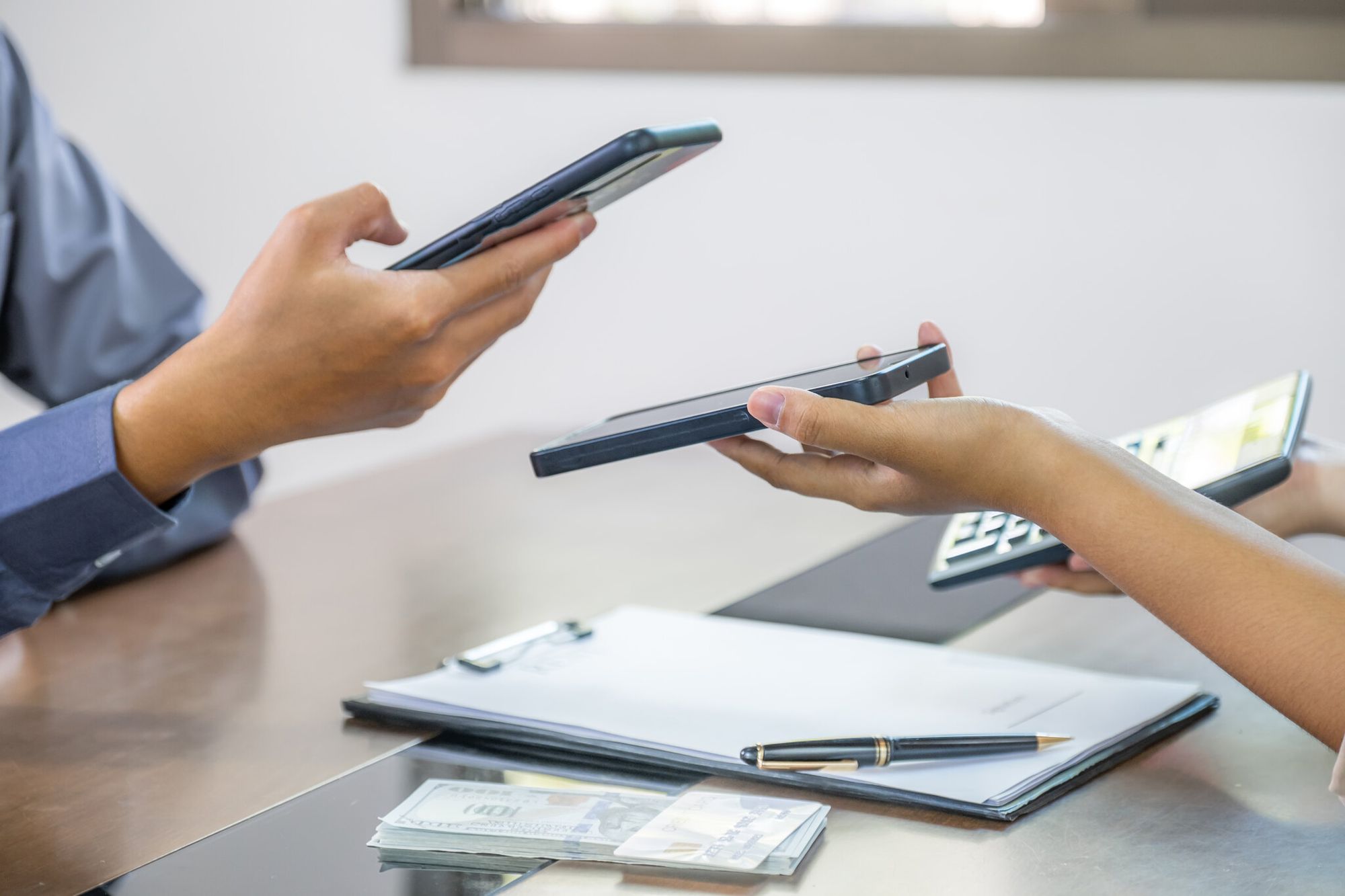 a hand scanning a QR code at a meeting