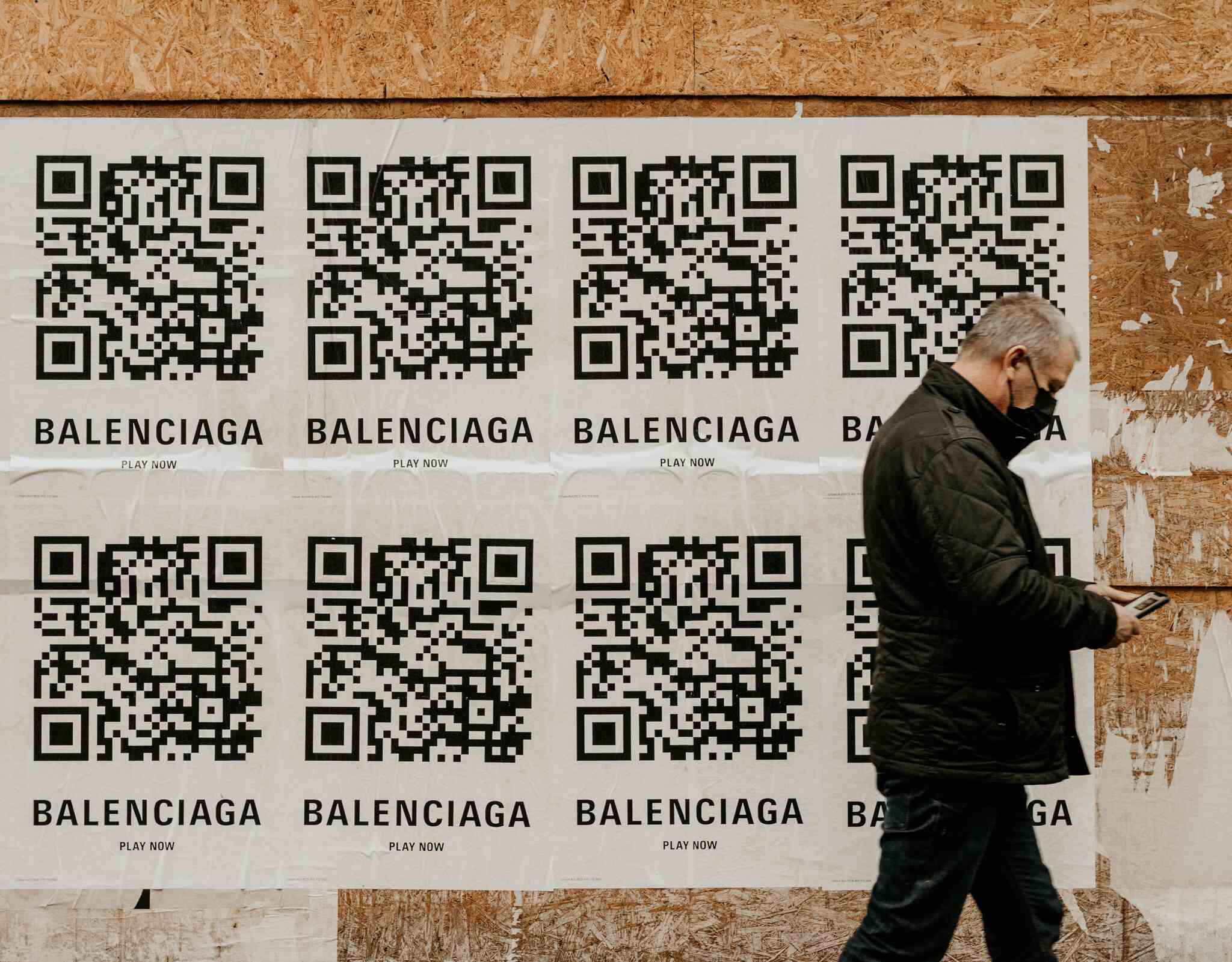 QR code of balenciaga and a man wearing a mask walking