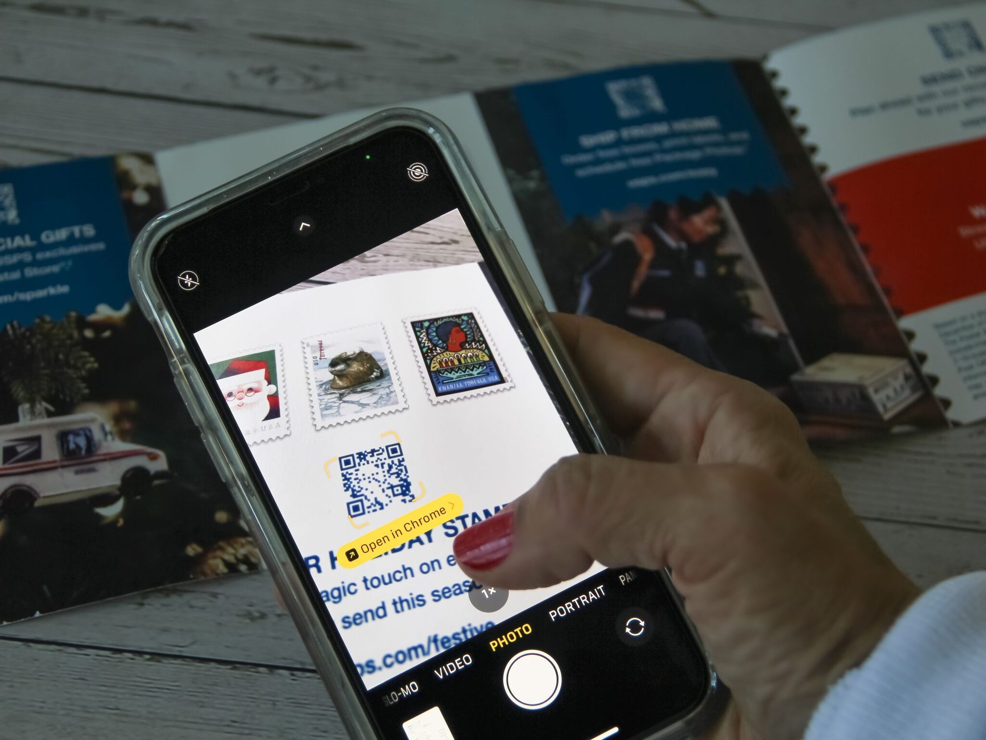 a woman scanning a QR code with a phone on a paper