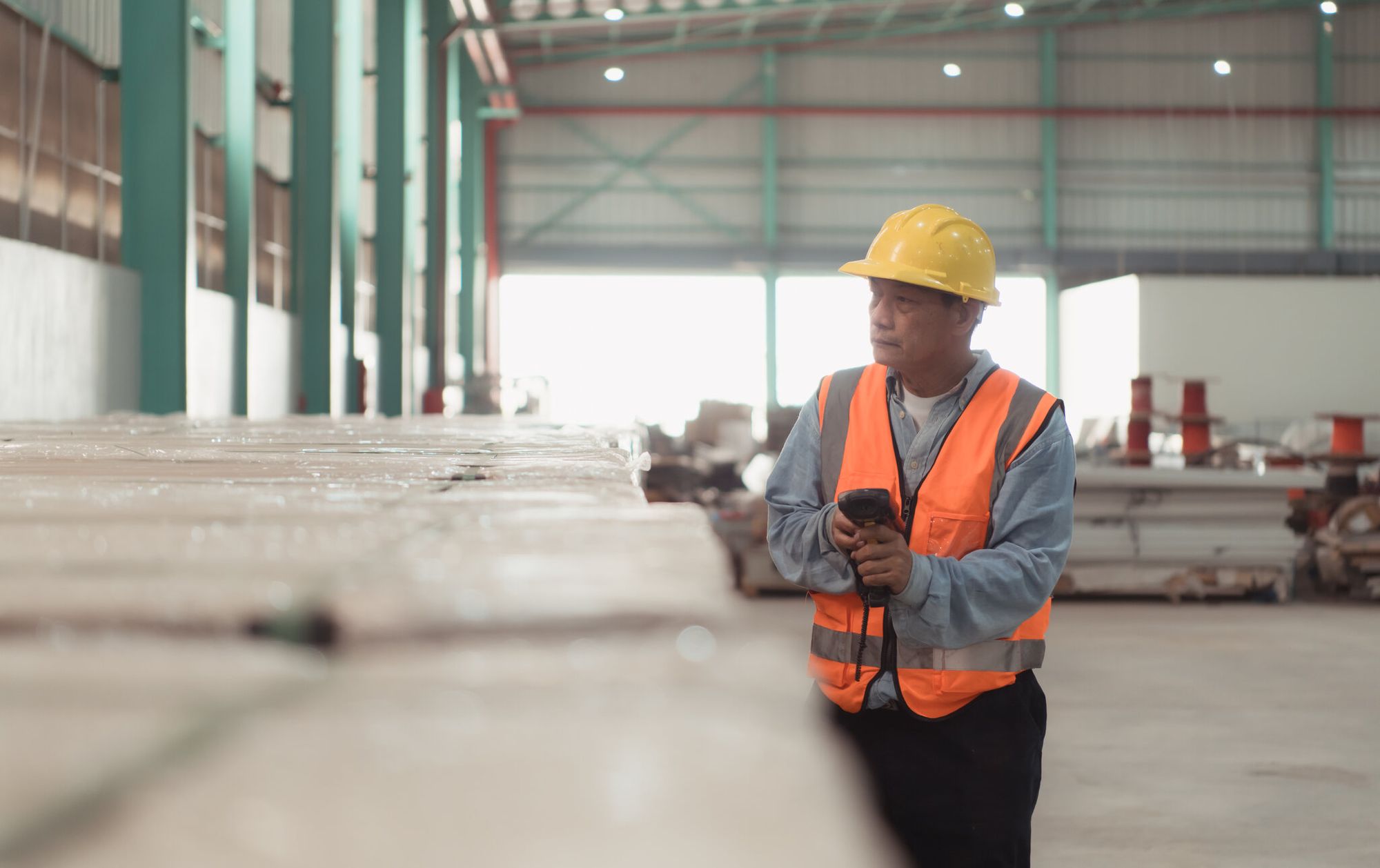 a worker examining products in inventory with a QR code