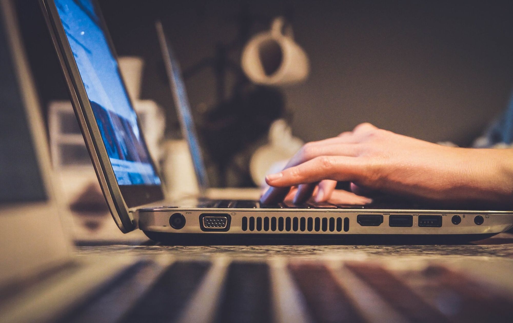 A person using a laptop and typing