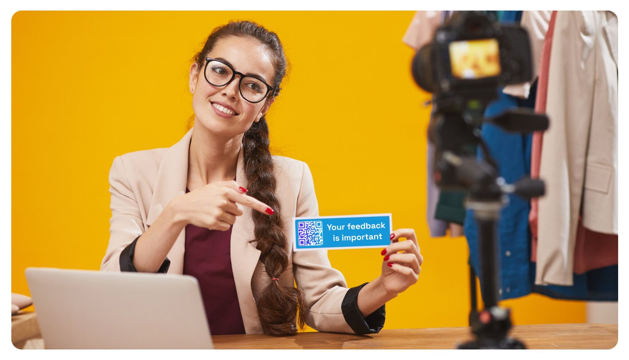 a woman smiling and holding a card that says "your feedback is important" with a QR code