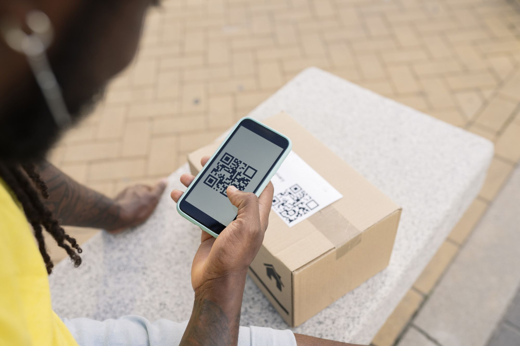 hand of delivery man with QR code